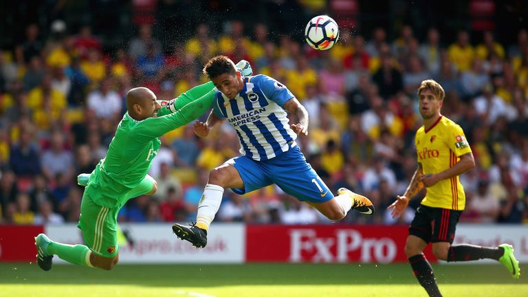 Heurelho Gomes punches the ball away from the head of Anthony Knockaert
