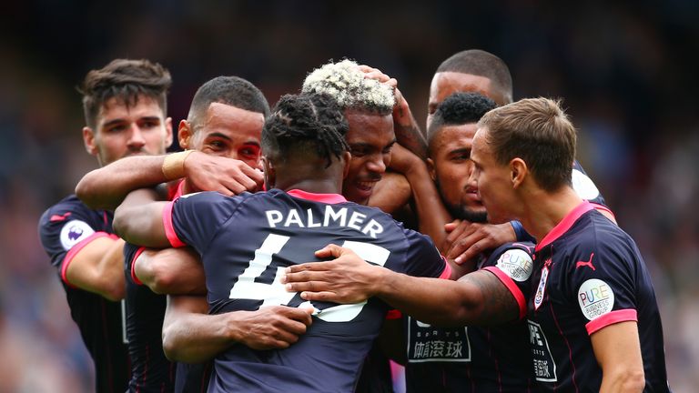 Steve Mounie is mobbed by team-mates after scoring Huddersfield's second goal