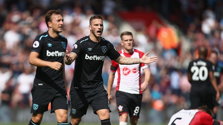 Marko Arnoutovic reacts after being shown a red card at St Mary's