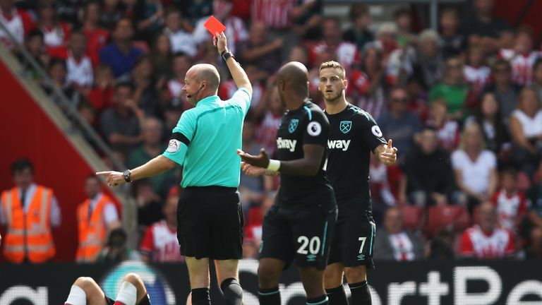 Marko Arnautovic looks on in disbelief as referee Lee Mason shows him a red card