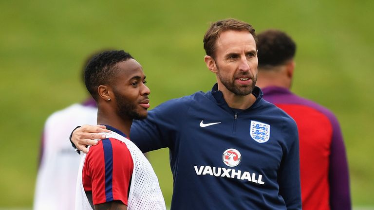 Raheem Sterling speaks with Gareth Southgate during an England training session