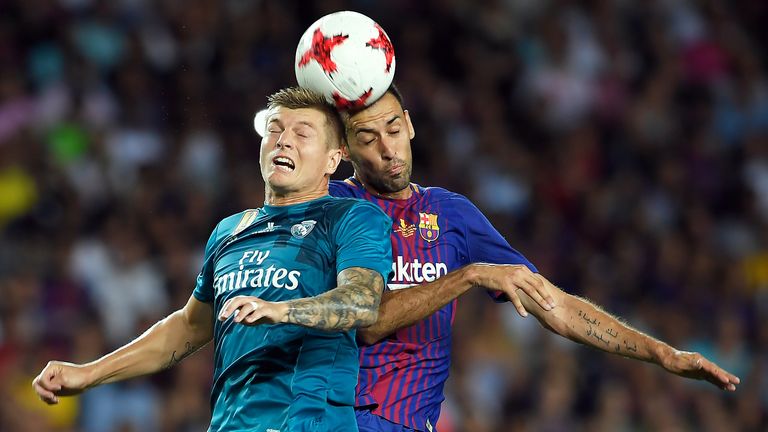 Toni Kroos and Sergio Busquets contest a header during the Spanish Super Cup Final, First Leg