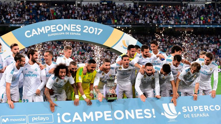Real Madrid players celebrate their Supercup trophy after winning the second leg of the Spanish Supercup football match Real Madrid vs FC Barcelona at the 
