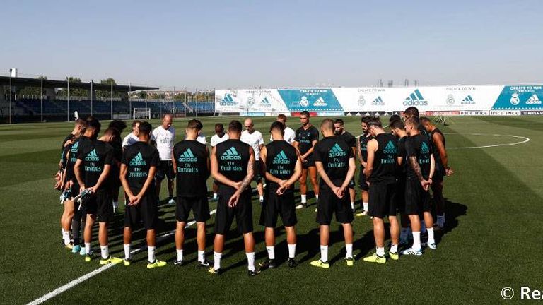 The Real Madrid squad observe a minute's silence at training