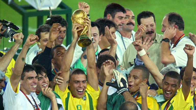 YOKOHAMA, JAPAN:  Brazil's forward Ronaldo (C), flanked by teammates, hoists the World Cup trophy during the award ceremony at the International Stadium Yo