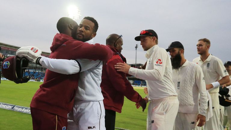 West Indies' Shai Hope (2L) is followed by England's captain Joe Root and the England squad as he leaves the field after winning the second Test