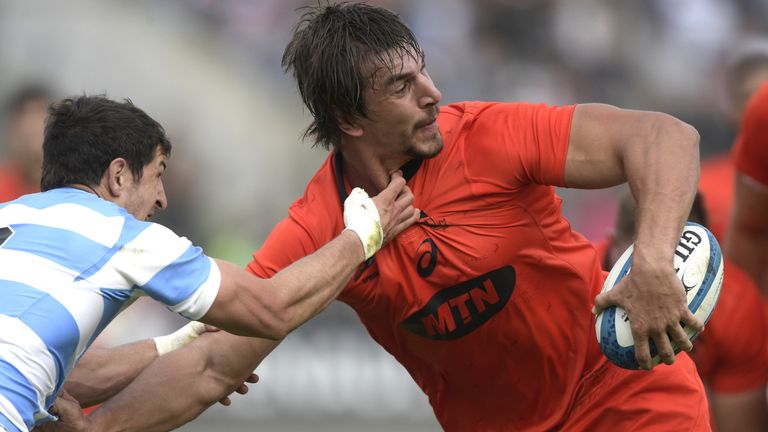 South Africa's lock Eben Etzebeth (R) runs through a tackle by Argentina's scrum-half Tomas Cubelli