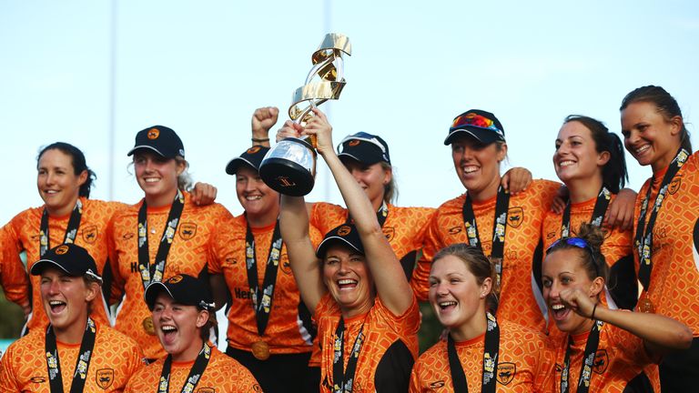 CHELMSFORD, ENGLAND - AUGUST 21:  Charlotte Edwards, captain of Southern Vipers lifts the trophy with the team after victory in their final match against W