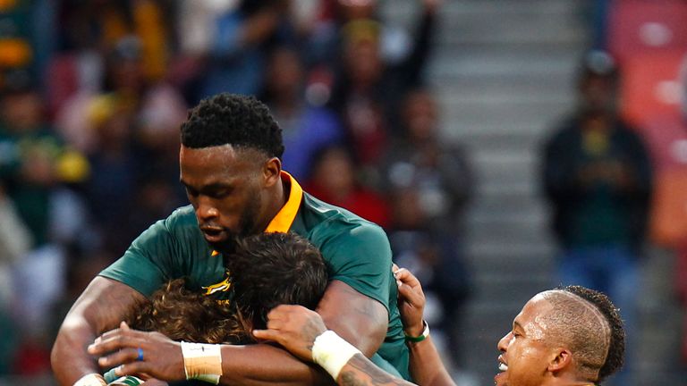 Springboks winger Courtnall Skosan (L/11#) is mobbed by teammates as he celebrates scoring a try during the International Rugby Test match between Argentin