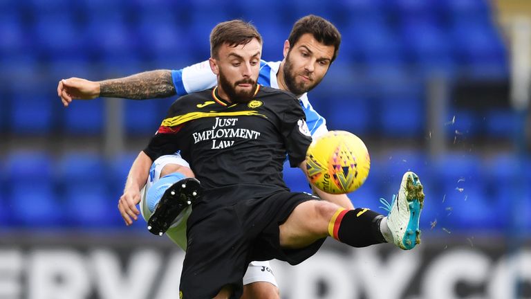 Partick Thistle's Steven Lawless  competes with St Johnstone's Richard Foster (partially hidden).