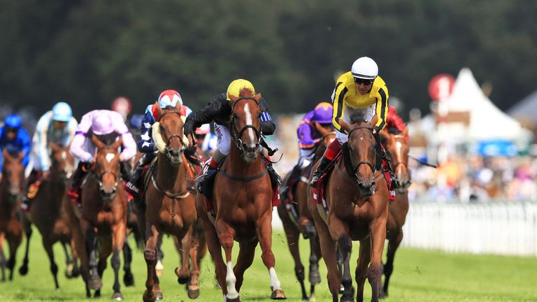 Stradivarius ridden by jockey Andrea Atzeni (centre left) wins the Qatar Goodwood Cup Stakes from Big Orange (right)