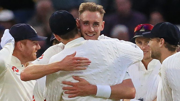 England bowler Stuart Broad (C) celebrates with teammates after taking the wicket of West Indies' captain Jason Holder