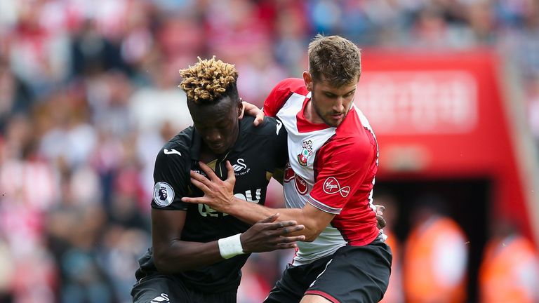 Tammy Abraham of Swansea City and Jack Stephens of Southampton battle for possession during the Premier League match