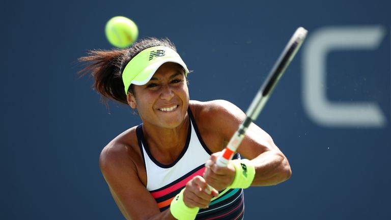 Heather Watson of Great Britain returns a shot during the first round Women's Singles match against Alize Cornet of France