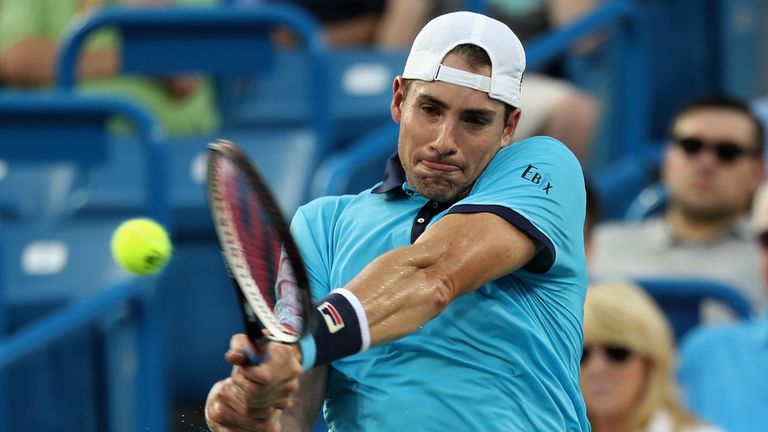 John Isner returns a shot to Tommy Paul during the Western and Southern Open