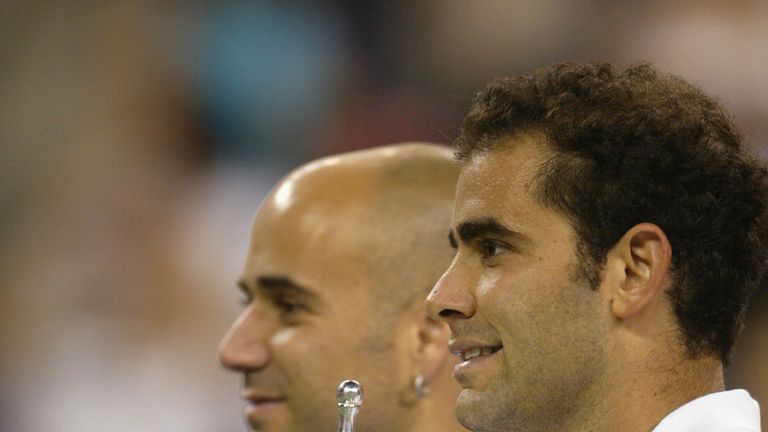 Pete Sampras poses with his trophy and Andre Agassi during the US Open September 8, 2002