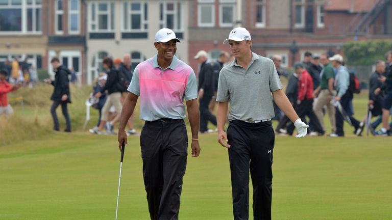 US golfer Jordan Spieth (L) and US golfer Tiger Woods share a joke on the 3rd green during their third rounds, on day three of the 2014 British Open Golf C