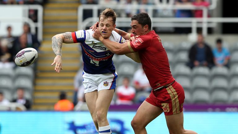 Tom Johnstone of Wakefield Wildcats (L) tackled by Tony Gigot of Catalans Dragons during 2017 Magic Weekend in Newcastle