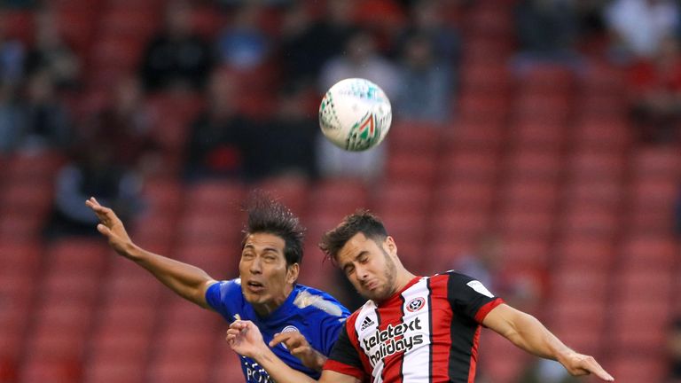 Leicester City's Leonardo Ulloa (left) and Sheffield United's George Baldock battle for the ball in the air during the Carabao Cup, Second Round match