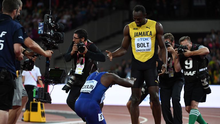 US athlete Justin Gatlin (L) bends down to Jamaica's Usain Bolt after the final of the men's 100m athletics event at the 2017 IAAF World Championships at t