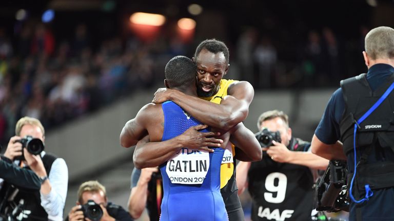 Jamaica's Usain Bolt (R) embraces US athlete Justin Gatlin after the final of the men's 100m athletics event at the 2017 IAAF World Championships at the Lo