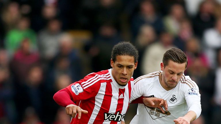 SWANSEA, WALES - FEBRUARY 13: Virgil van Dijk of Southampton and Gylfi Sigurdsson of Swansea City compete for the ball during the Barclays Premier League m