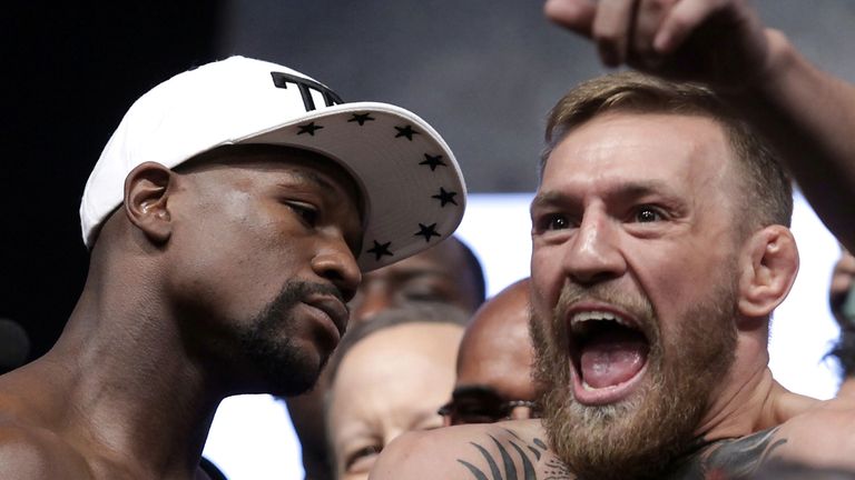 Boxer Floyd Mayweather Jr. (L) and MMA figher Connor Mcgregor pose during their weigh- in on August 25, 2017, in Las Vegas