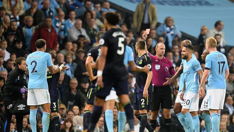 MANCHESTER, ENGLAND - AUGUST 21:  Kyle Walker of Manchester City (L) is shown a second yellow card leading to being sent off during the Premier League matc