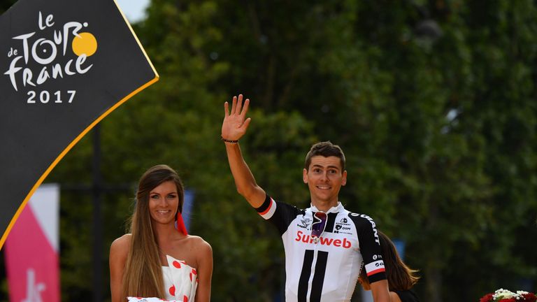 France's Warren Barguil celebrates his polka dot jersey of best climber on the podium at the end of the 103 km twenty-first and last stage of the 104th edi