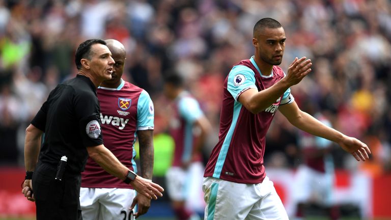 STRATFORD, ENGLAND - MAY 14: Winston Reid of West Ham United and Neil Swarbrick argue during the Premier League match between West Ham United and Liverpool
