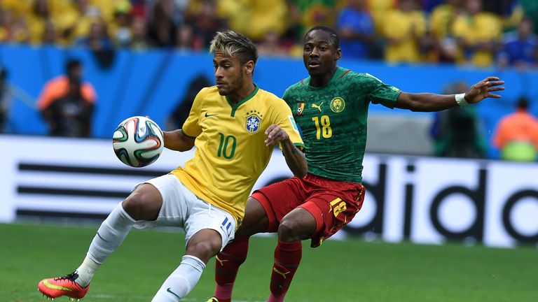 Brazil's forward Neymar and Cameroon's midfielder Eyong Enoh vie for the ball during their Group A match during the 2014 FIFA World Cup