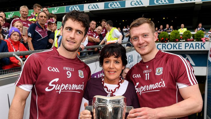 Margaret Keady with the Liam MacCarthy Cup and Galway captain, David Burke , left, and Joe Canning