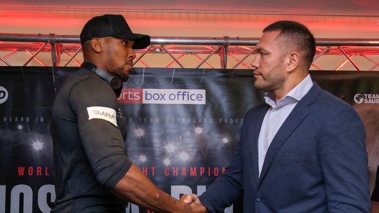 Britain's Anthony Joshua (L) and Bulgaria's Kubrat Pulev (R) shake hands during a press conference at the Principality Stadium in Cardiff on September 11, 