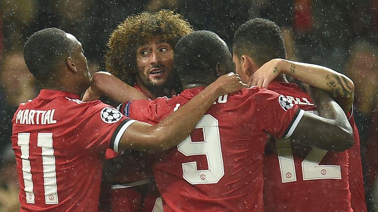 Marouane Fellaini celebrates with team-mates after scoring Manchester United's opening goal in their 3-0 UEFA Champions League Group A win over Basel