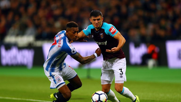 Aaron Cresswell of West Ham United and Rajiv van La Parra of Huddersfield Town battle for the ball during the Premier Leag
