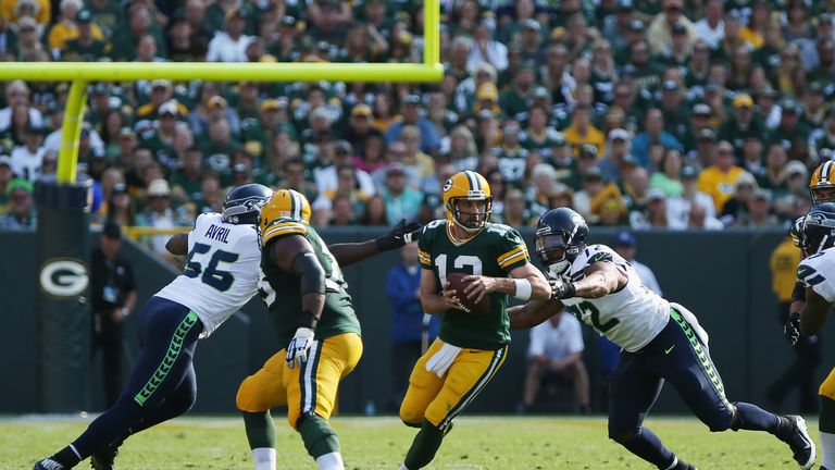 GREEN BAY, WI - SEPTEMBER 10:  Michael Bennett #72 of the Seattle Seahawks sacks Aaron Rodgers #12 of the Green Bay Packers during the first half at Lambea