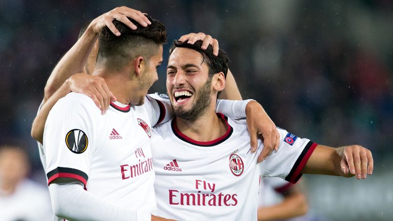 AC Milan's forward from Portugal Andre Silva (L) celebrates scoring with midfielder from Turkey Hakan Calhanoglu during the UEFA Europa League group D foot