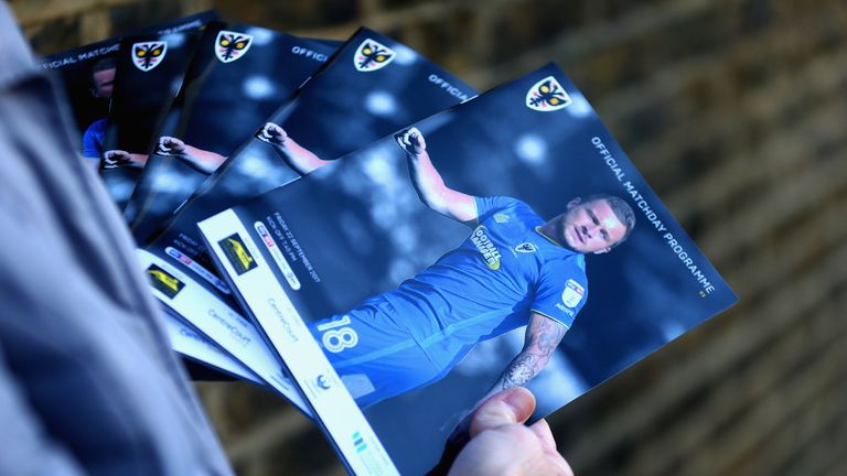 KINGSTON UPON THAMES, ENGLAND - SEPTEMBER 22: A detailed view as a programme seller holds the match programme prior to the Sky Bet League One match between