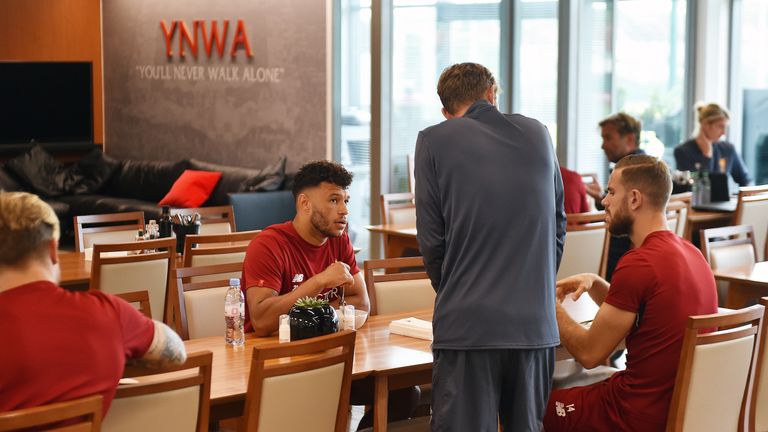 Alex Oxlade-Chamberlain has lunch with team-mate Jordan Henderson at Liverpool's Melwood Training Facility