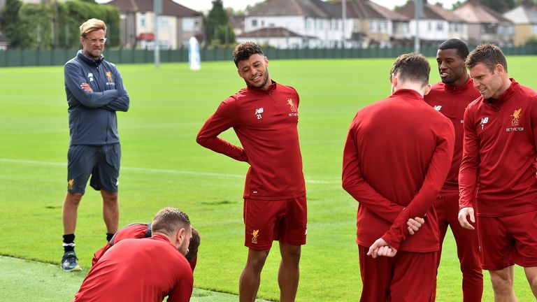 Jurgen Klopp looks on as Alex Oxlade-Chamberlain takes part in his first training session at Melwood since moving from Arsenal