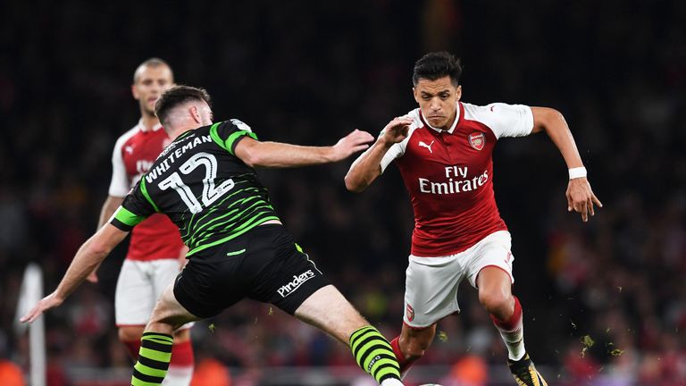 Alexis Sanchez of Arsenal takes on Ben Whiteman during the Carabao Cup match against Doncaster Rovers