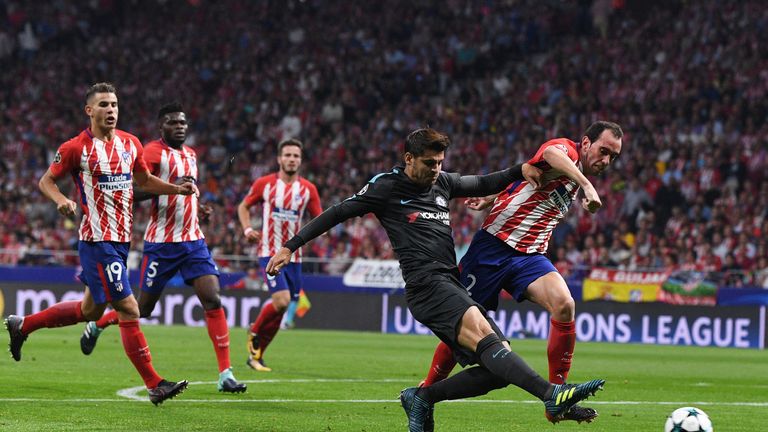 MADRID, SPAIN - SEPTEMBER 27:  Diego Godin of Atletico Madrid holds off Alvaro Morata of Chelsea during the UEFA Champions League group C match between Atl