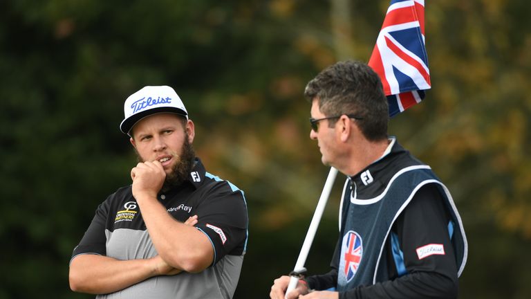 WATFORD, ENGLAND - OCTOBER 14:  Andrew Johnston of England consults wth his caddy whilst on the ninth green during the second round of the British Masters 