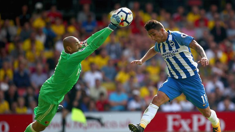 WATFORD, ENGLAND - AUGUST 26:  Heurelho Gomes of Watford punches the ball before Anthony Knockaert of Brighton and Hove Albion can get his head to the ball