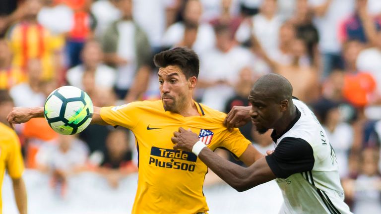 Atletico Madrid's midfielder from Argentina Nico Gaitan (L) vies with Valencia's midfielder from France Geoffrey Kondogbia during the Spanish Liga football