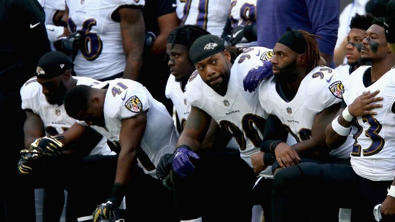 LONDON, ENGLAND - SEPTEMBER 24:  Baltimore Ravens players kneel for the American National anthem during the NFL International Series match between Baltimor