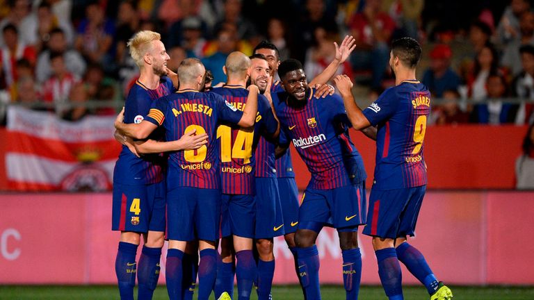 Barcelona players celebrate after taking the lead through a Girona own goal