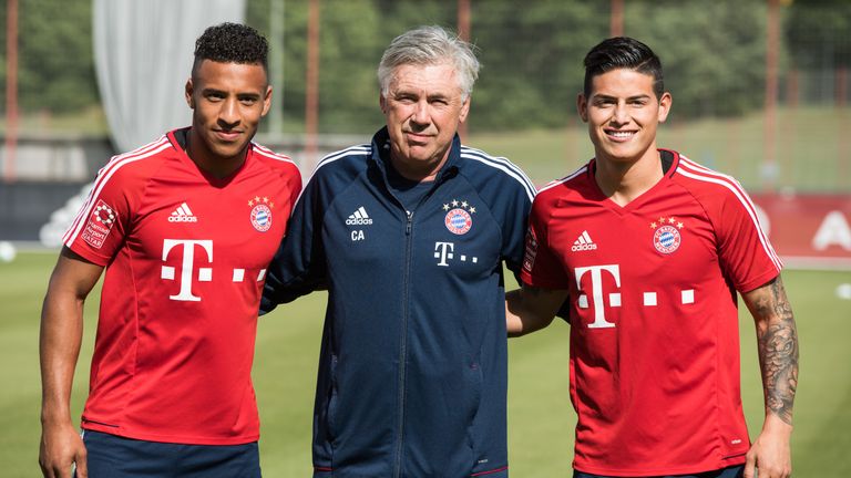 MUNICH, GERMANY - JULY 12: Head coach Carlo Ancelotti poses with Corentin Tolisso (L) and James Rodriguez before a training session at Saebener Strasse tra