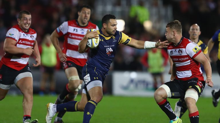 Ben Te'o of Worcester hands off Ruan Ackermann (R) of Gloucester 