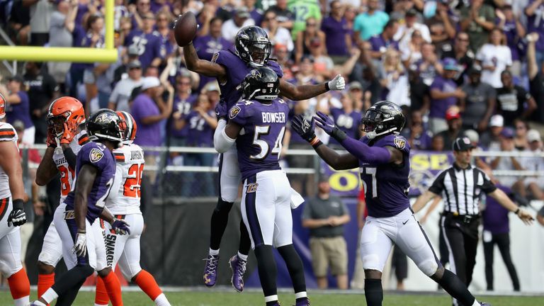 BALTIMORE, MD - SEPTEMBER 17: Cornerback Brandon Carr #24 of the Baltimore Ravens celebrates with  Tyus Bowser #54 and  C.J. Mosley #57 after intercepting 